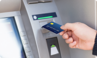 credit card being inserted into ATM machine