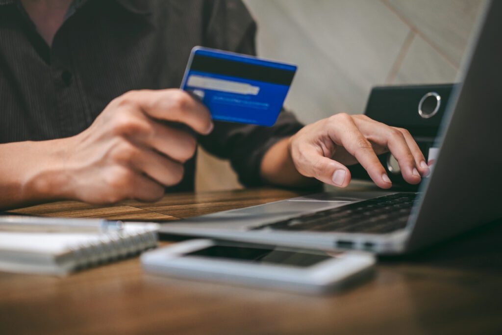 Businessman holding credit card and typing on laptop for online shopping and payment makes a purchase on the Internet, Online payment, Business financial and technology.